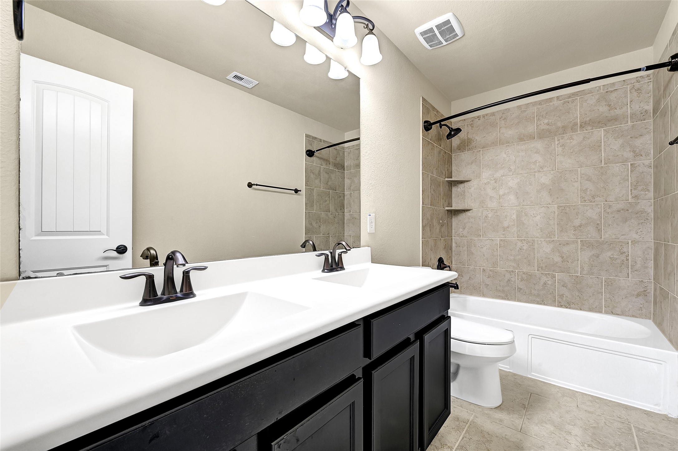 31796 Chapel Rock Lane Spring, TX 77386 - Photo 25 of 30 a bathroom with a sink a toilet a mirror a bathtub and shower