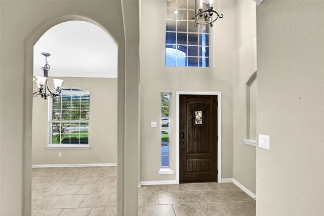 an entrance view of a livingroom with windows
