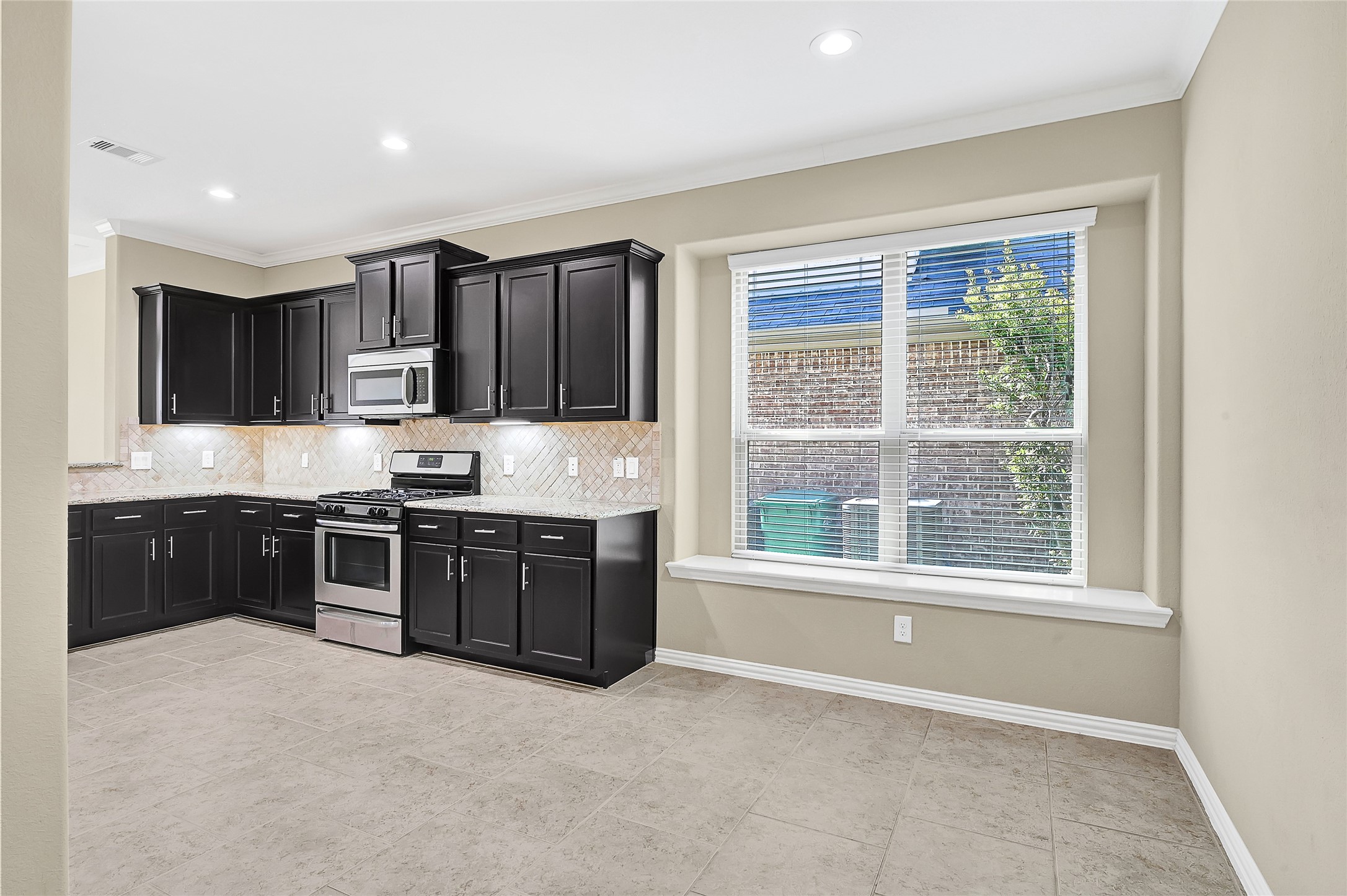 31796 Chapel Rock Lane Spring, TX 77386 - Photo 7 of 30 a large kitchen with stainless steel appliances granite countertop a stove a sink and a microwave