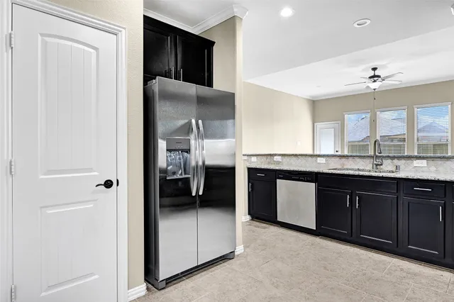a kitchen with stainless steel appliances granite countertop a refrigerator and a sink