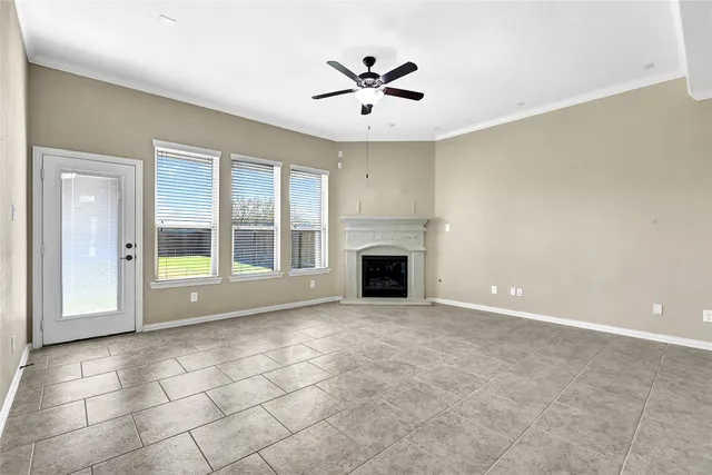 an empty room with fireplace and windows