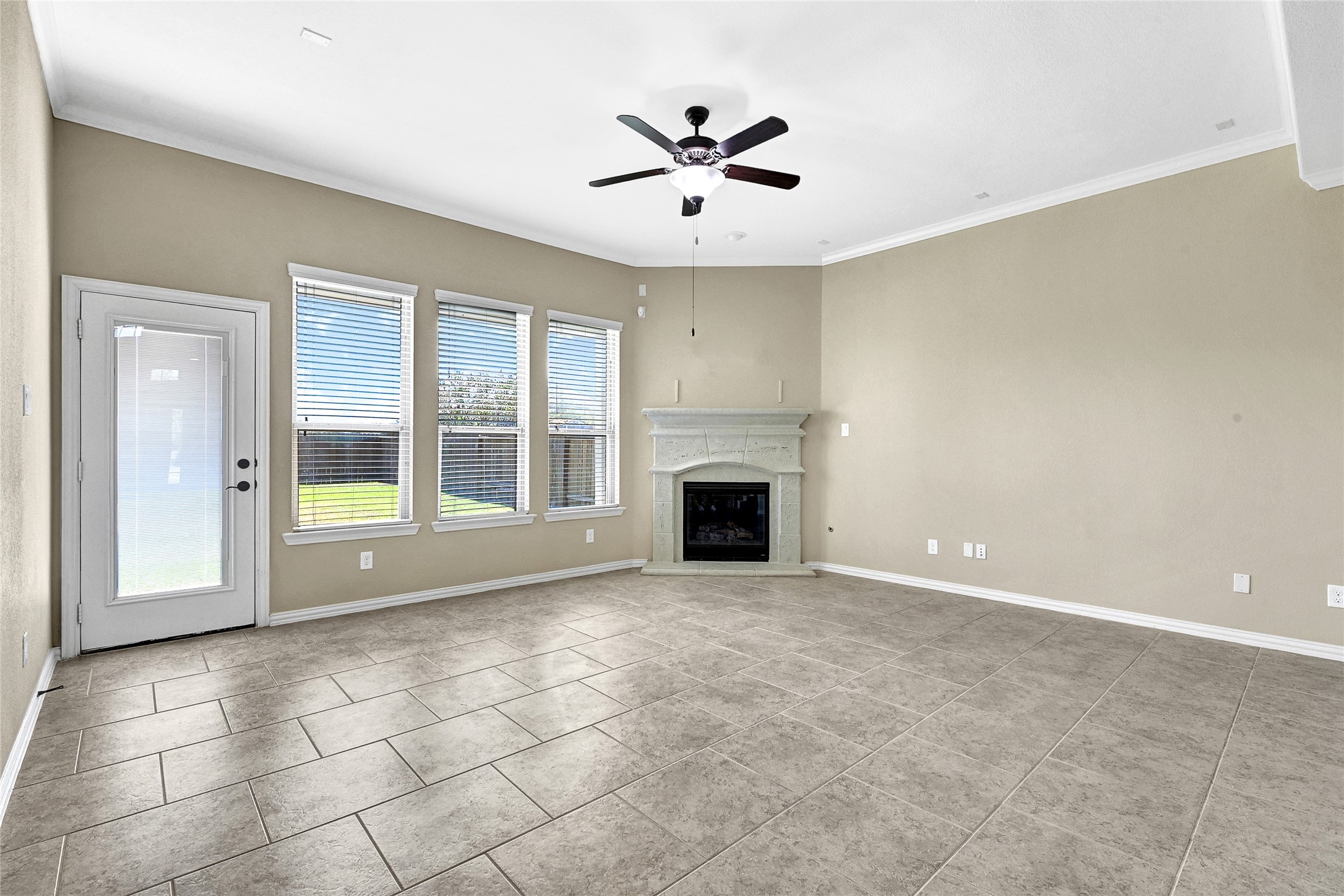 31796 Chapel Rock Lane Spring, TX 77386 - Photo 10 of 30 an empty room with fireplace and windows