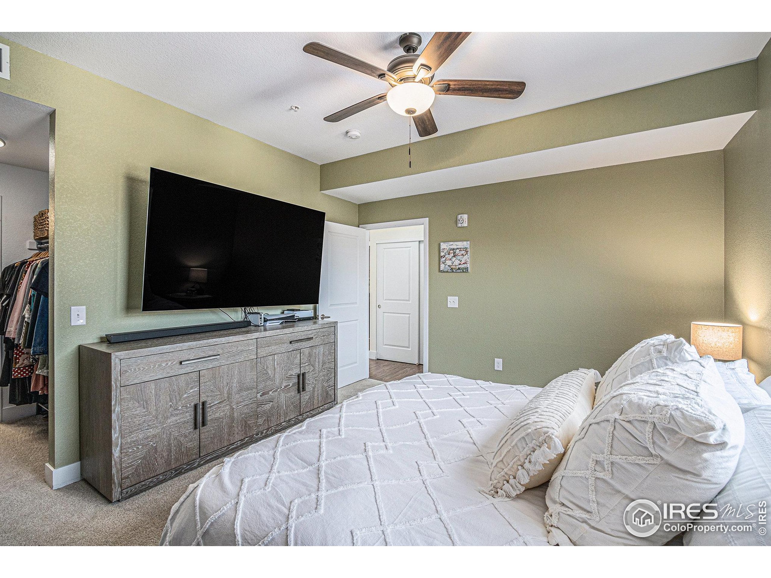 220 Willow Street, Unit 301 Fort Collins, CO 80524 - Photo 11 of 27 a bedroom with a bed and a flat screen tv