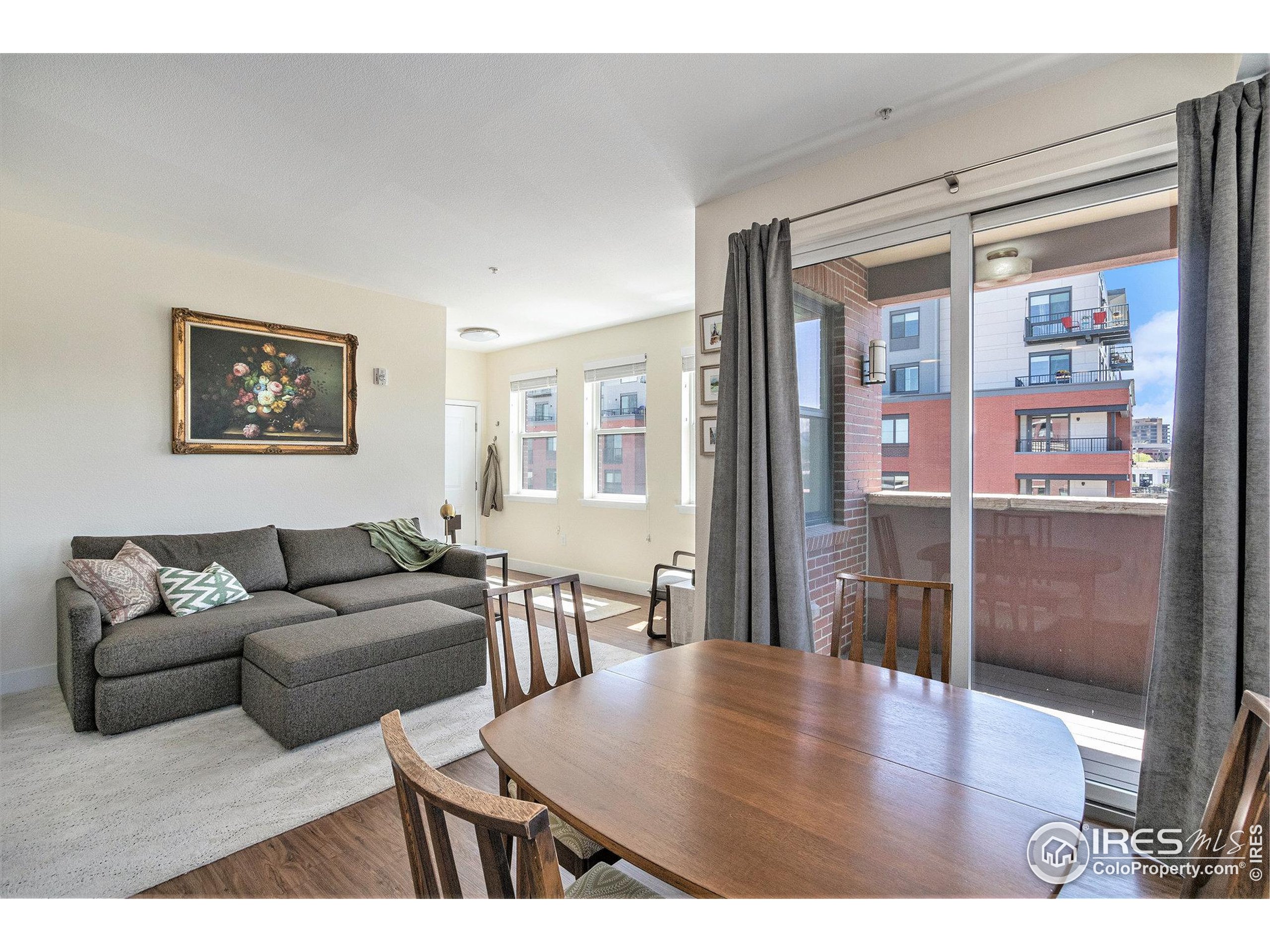 220 Willow Street, Unit 301 Fort Collins, CO 80524 - Photo 3 of 27 a living room with furniture wooden floor and a large window