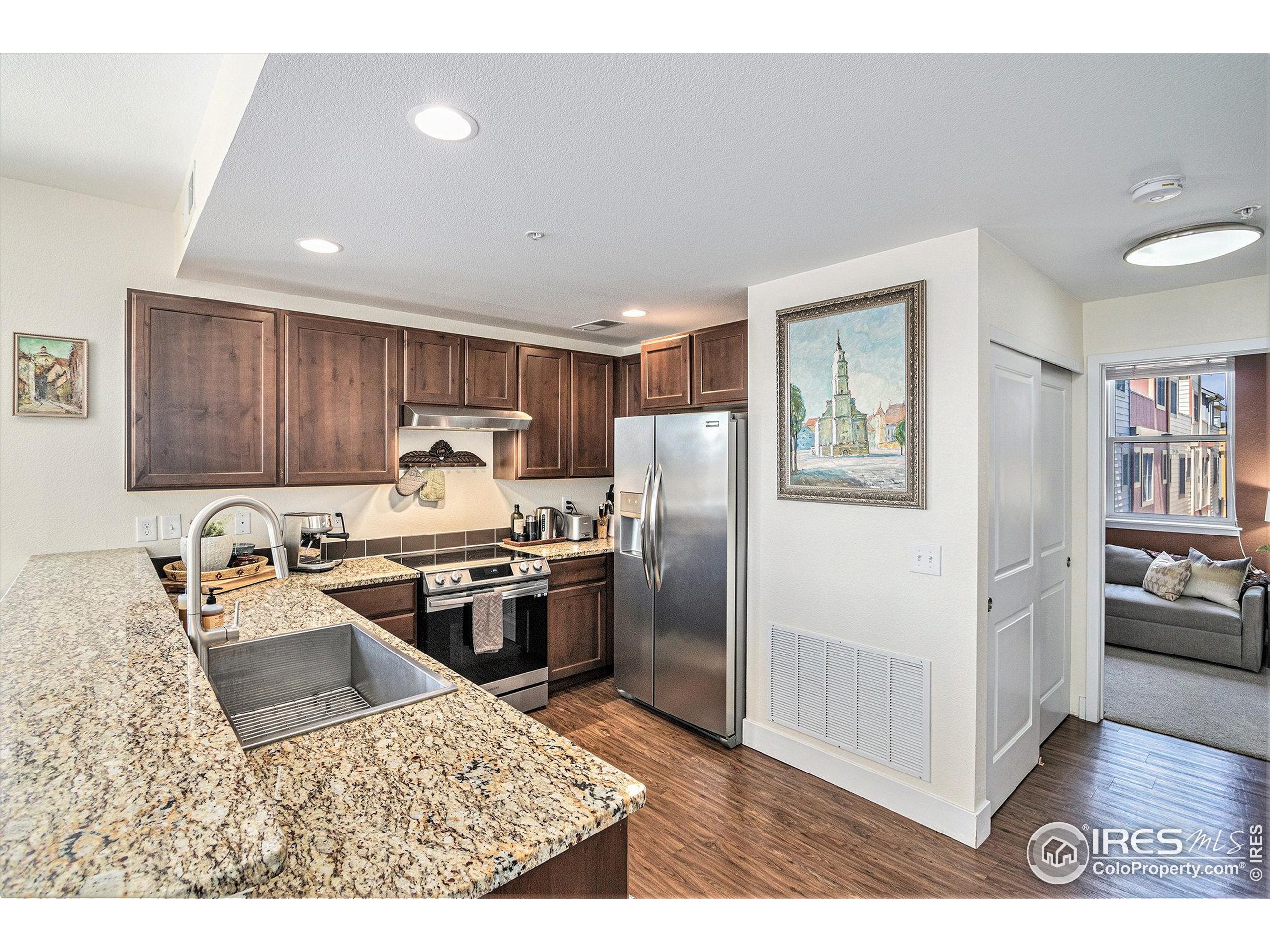 220 Willow Street, Unit 301 Fort Collins, CO 80524 - Photo 4 of 27 a kitchen with stainless steel appliances granite countertop a refrigerator sink and stove
