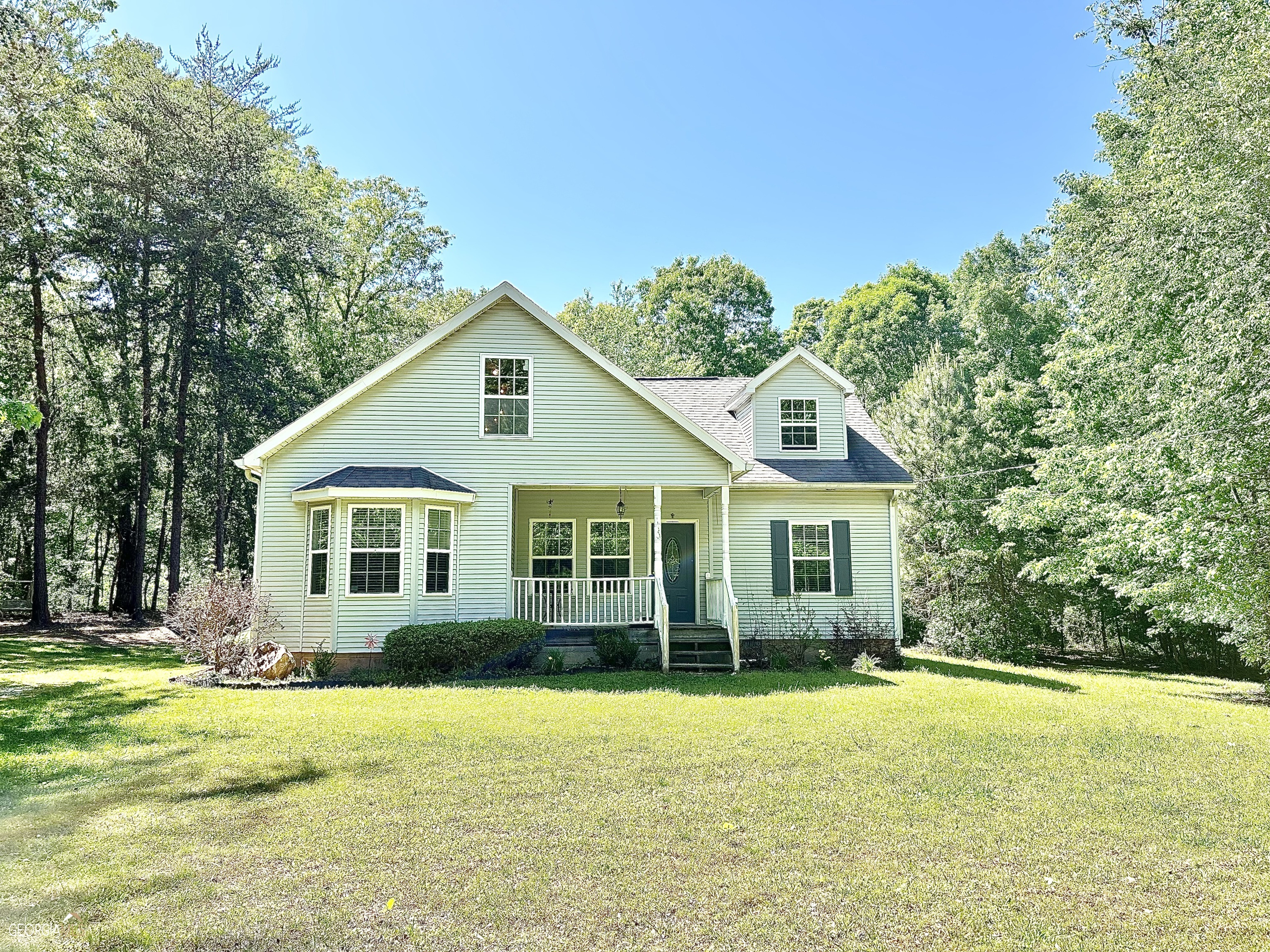 a view of a house with a yard and swimming pool