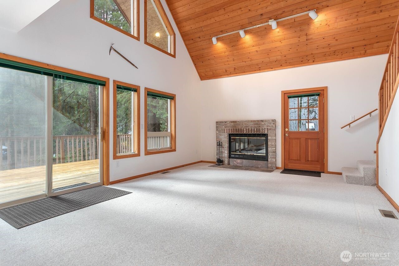 7132 St Helen's Place Deming, WA 98244 - Photo 5 of 35 a view of an empty room with a fireplace and a window