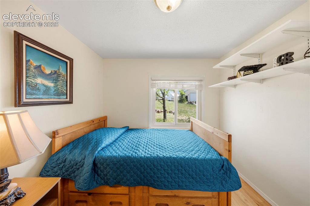 13075 Blaney Road South Peyton, CO 80831 - Photo 21 of 40 Bright interior room featuring a window with exterior views, light wood-finish flooring, and white walls