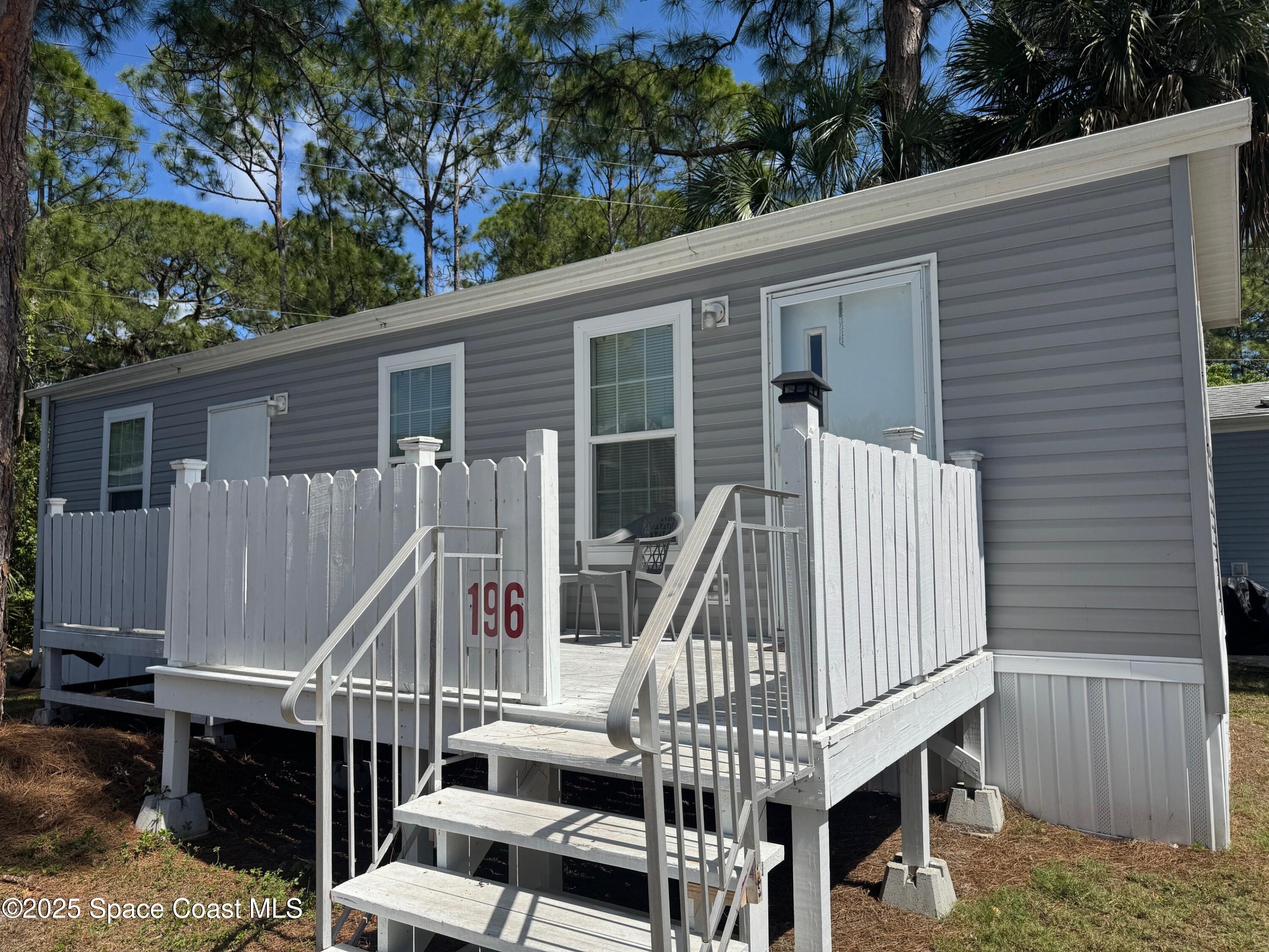 669 Snowbird Avenue, Unit 196 Cocoa, FL 32926 - Photo 1 of 6 a view of deck with furniture and garden
