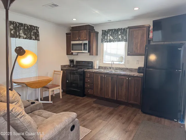 a kitchen with a sink cabinets and window