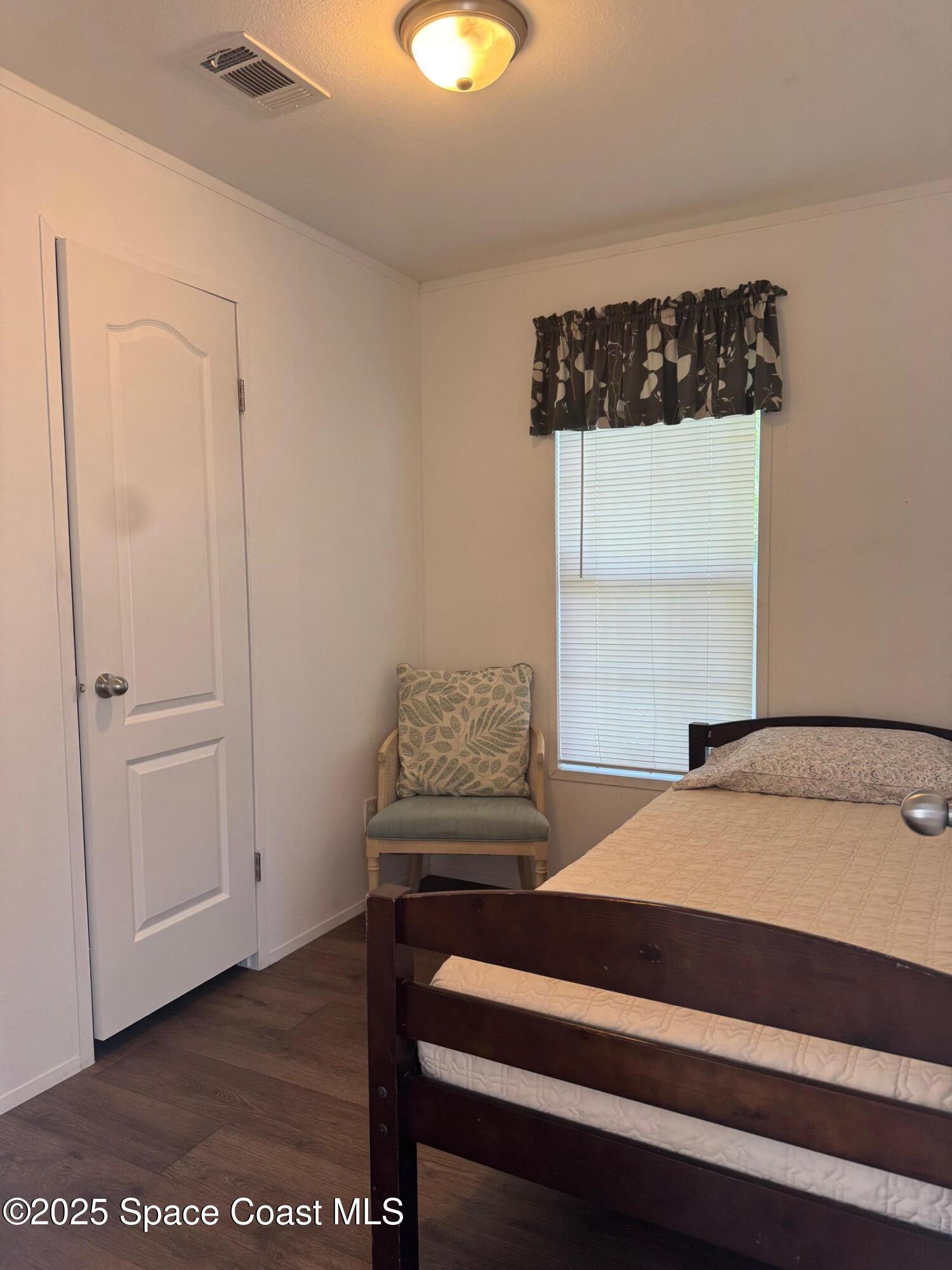 669 Snowbird Avenue, Unit 196 Cocoa, FL 32926 - Photo 5 of 6 a bedroom with a bed and cabinets