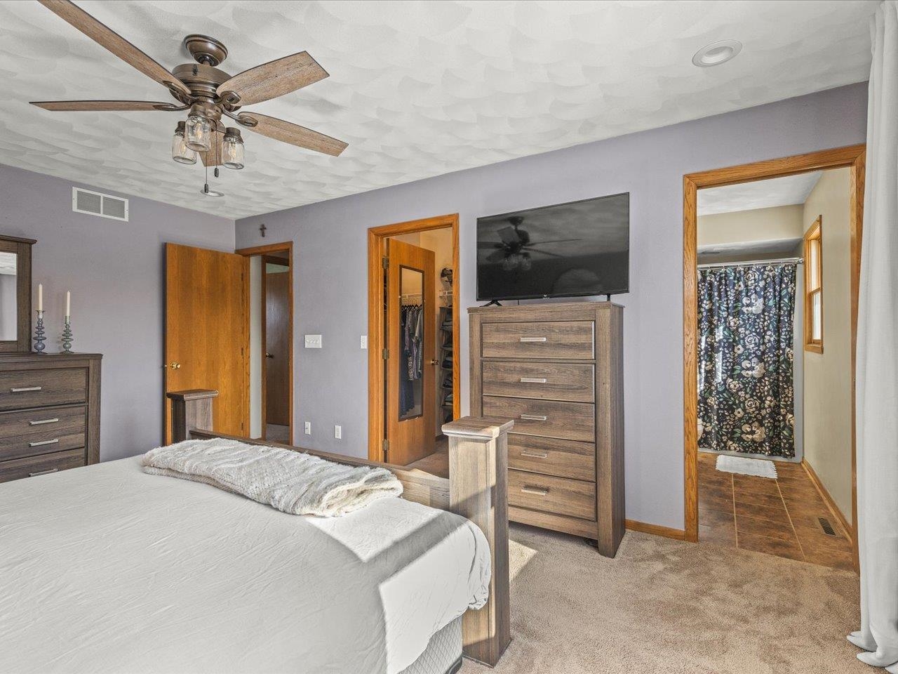 8629 Perth Lane Caledonia, IL 61011 - Photo 28 of 50 a bedroom with a bed and a chandelier