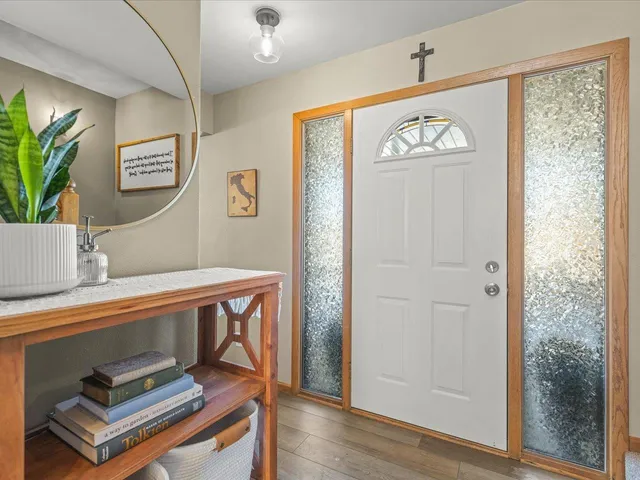 a view of a livingroom with furniture and a flat screen tv