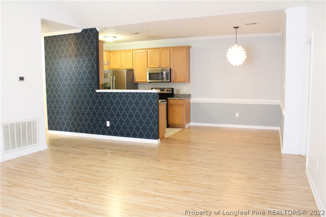 1324 Kershaw Loop, Unit 206 Fayetteville, NC 28314 - Photo 11 of 18 a view of an empty room with window and wooden floor