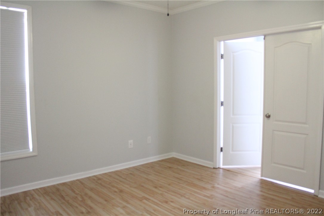 1324 Kershaw Loop, Unit 206 Fayetteville, NC 28314 - Photo 7 of 18 a view of an empty room with wooden floor