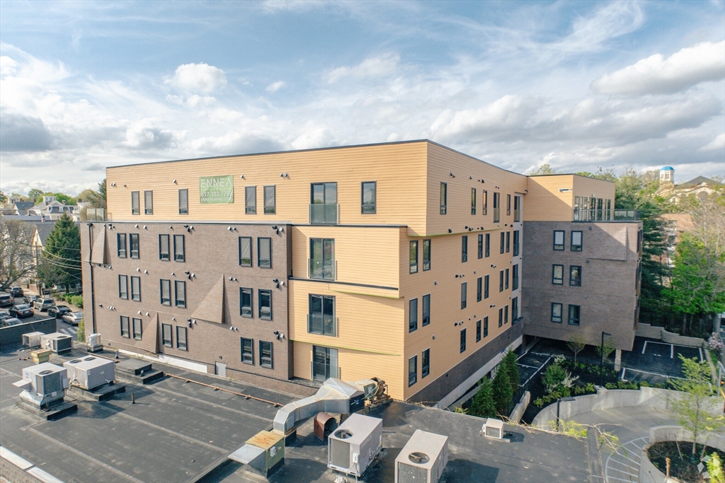 9 Central Street, Unit 405 Somerville, MA 02143 - Photo 21 of 24 a front view of a building with balcony