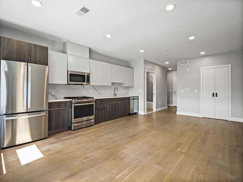 9 Central Street, Unit 405 Somerville, MA 02143 - Photo 5 of 24 a large kitchen with a refrigerator and a sink