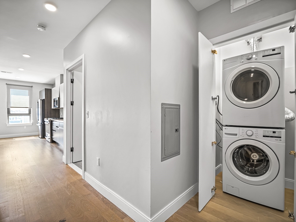 9 Central Street, Unit 405 Somerville, MA 02143 - Photo 9 of 24 a view of a hallway with washer and dryer