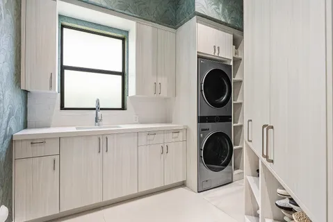 a kitchen with stainless steel appliances a sink stove and cabinets