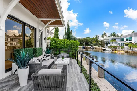 an aerial view of a house with outdoor space pool and lake view