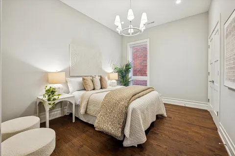 a bedroom with a bed and a chandelier