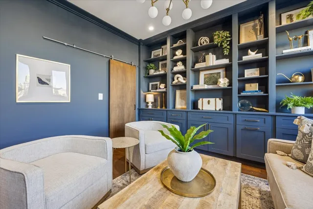 a living room with furniture potted plant and a book shelf