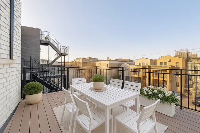 a view of a balcony with two chairs and a table