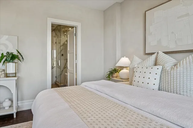 a bedroom with a bed and a potted plant