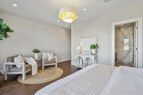 a bed room with a bed and a chandelier