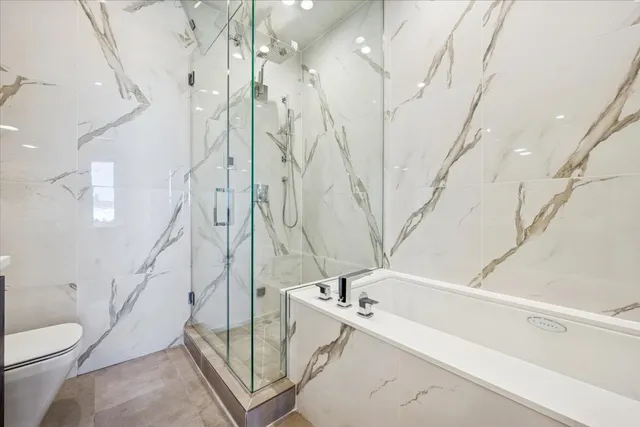 a bathroom with a bathtub and shower