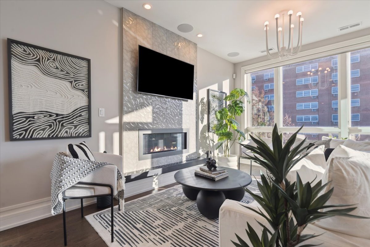 1448 West Chestnut Street, Unit 3 Chicago, IL 60642 - Photo 4 of 46 a living room with furniture a fireplace and a flat screen tv