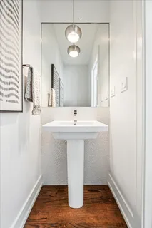 a living room with furniture a chandelier and a fireplace