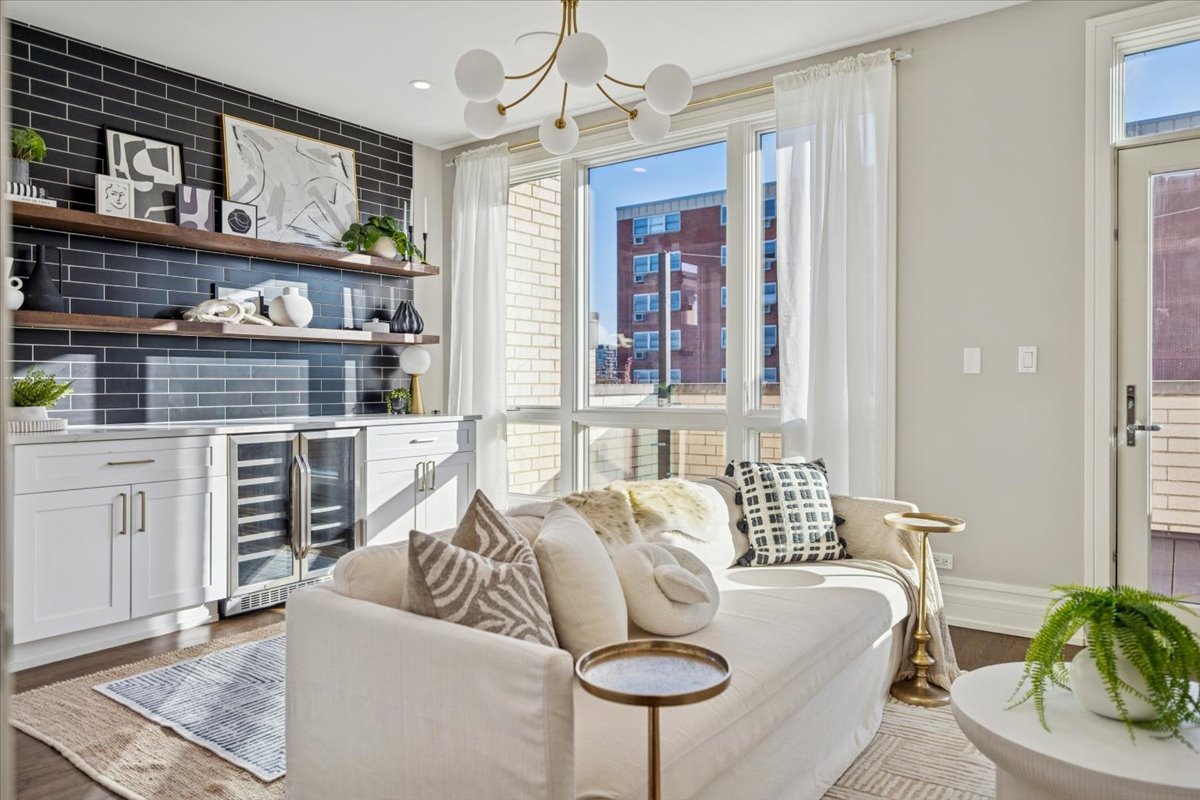 1448 West Chestnut Street, Unit 3 Chicago, IL 60642 - Photo 43 of 46 a living room with furniture a chandelier and a fireplace