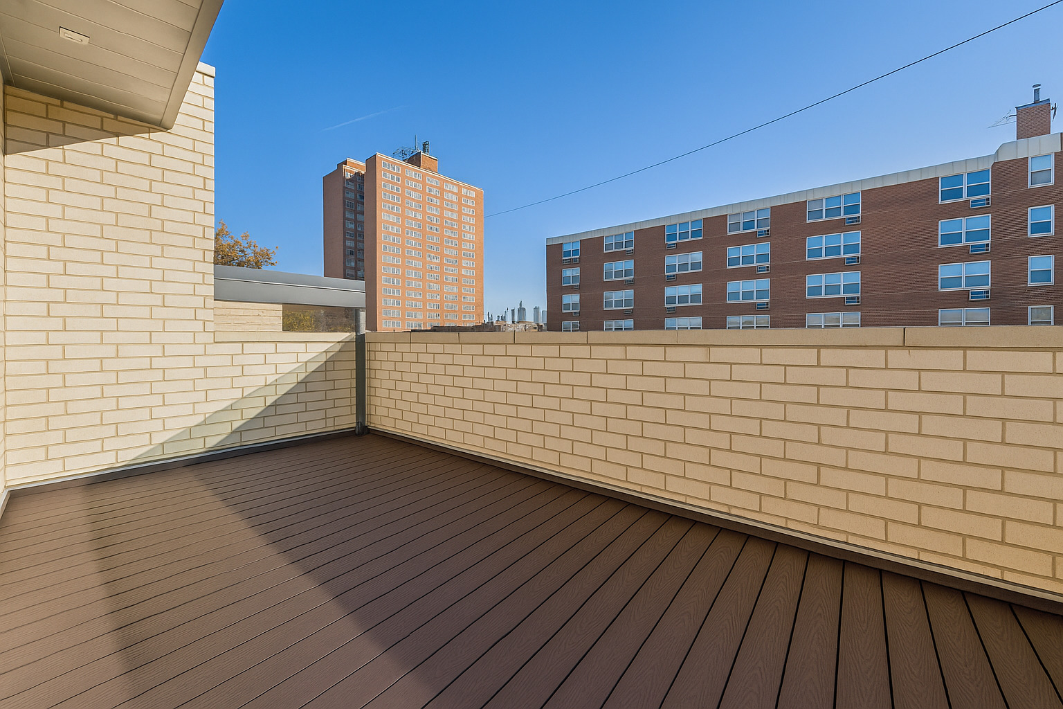 1448 West Chestnut Street, Unit 3 Chicago, IL 60642 - Photo 44 of 46 a view of a balcony with wooden floor and fence