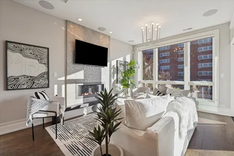 a living room with furniture a flat screen tv and a large window