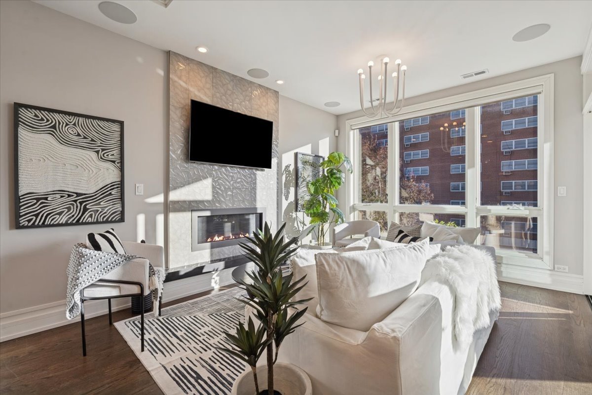 1448 West Chestnut Street, Unit 3 Chicago, IL 60642 - Photo 5 of 46 a living room with furniture a flat screen tv and a large window