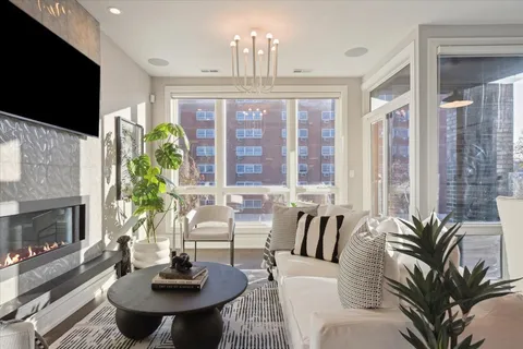 a living room with patio fireplace furniture and a flat screen tv