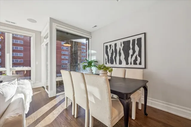 a view of a dining room with furniture window and wooden floor