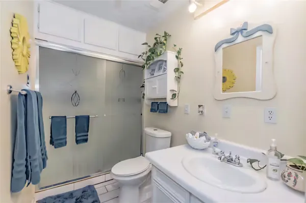 a bathroom with a sink a toilet and mirror