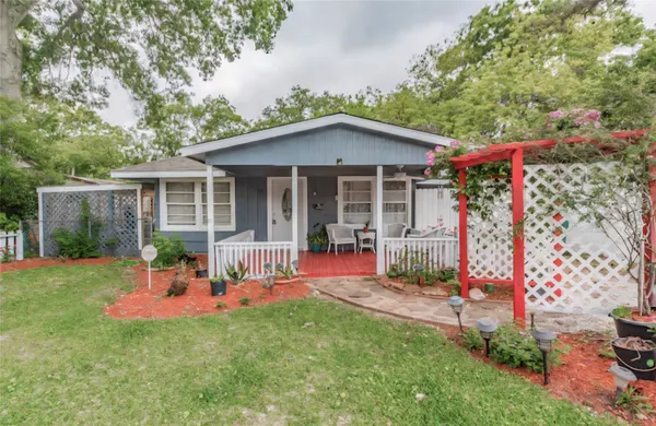 a front view of a house with a yard and porch