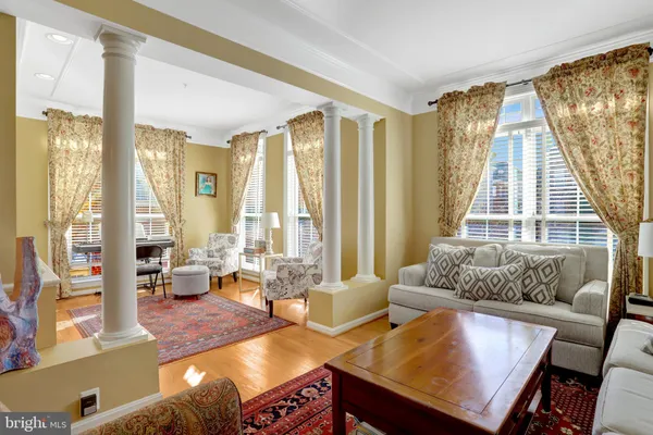 a living room with furniture and a book shelf