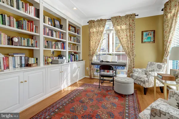 a living room with furniture and a book shelf