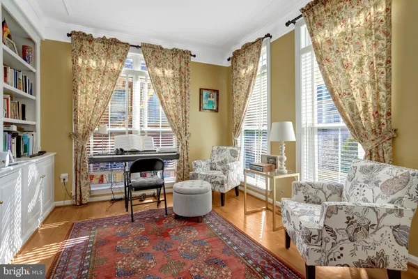 a living room with furniture and a book shelf