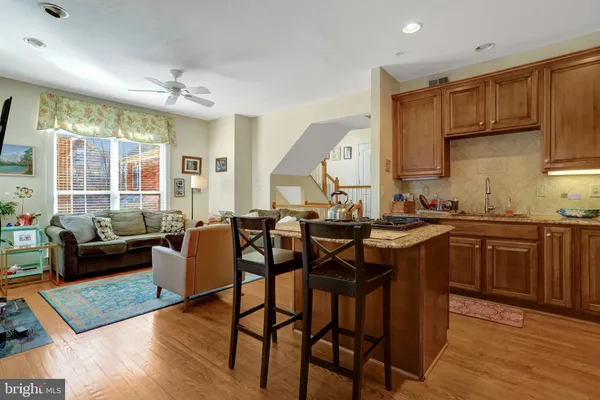 a bedroom with a bed and dresser with the shoe rack