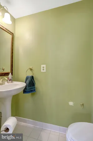 a bathroom with a sink vanity mirror and toilet