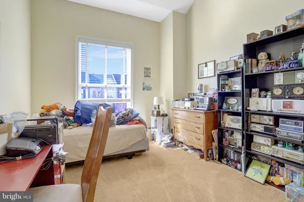 a living room with furniture a window and a flat screen tv