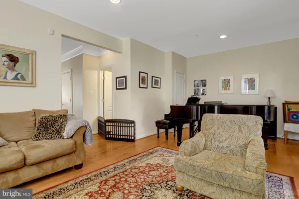 a view of a dining room with furniture a rug and wooden floor