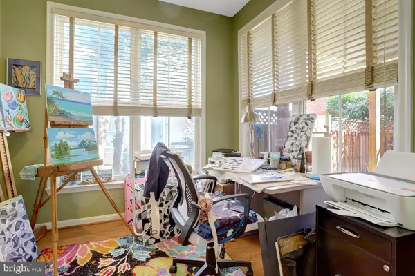 a view of an entryway with wooden floor and livingroom