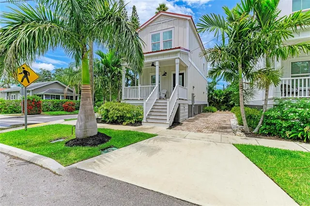 a front view of a house with a garden and plants