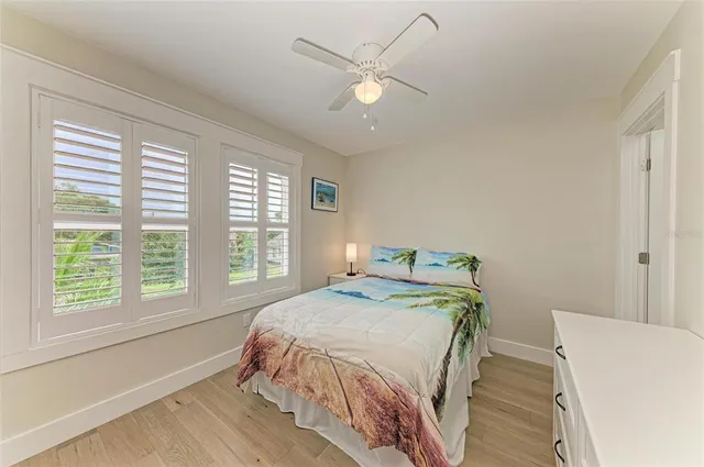 a bedroom with a large bed and a large window